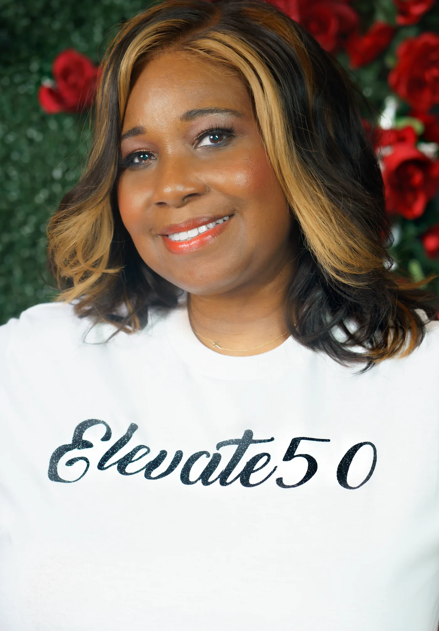 Ellen Coward wearing an Elevate50 branded shirt with red flowers